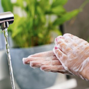 woman washing her hands with soap