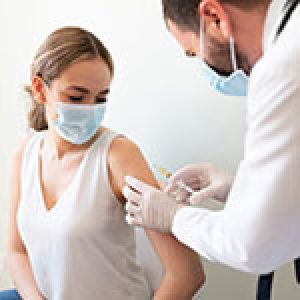 Doctor applying a vaccine on a woman's arm