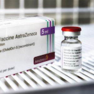 Astrazeneca  vaccine against the COVID-19 virus bottles with Vaccine Box on white tray